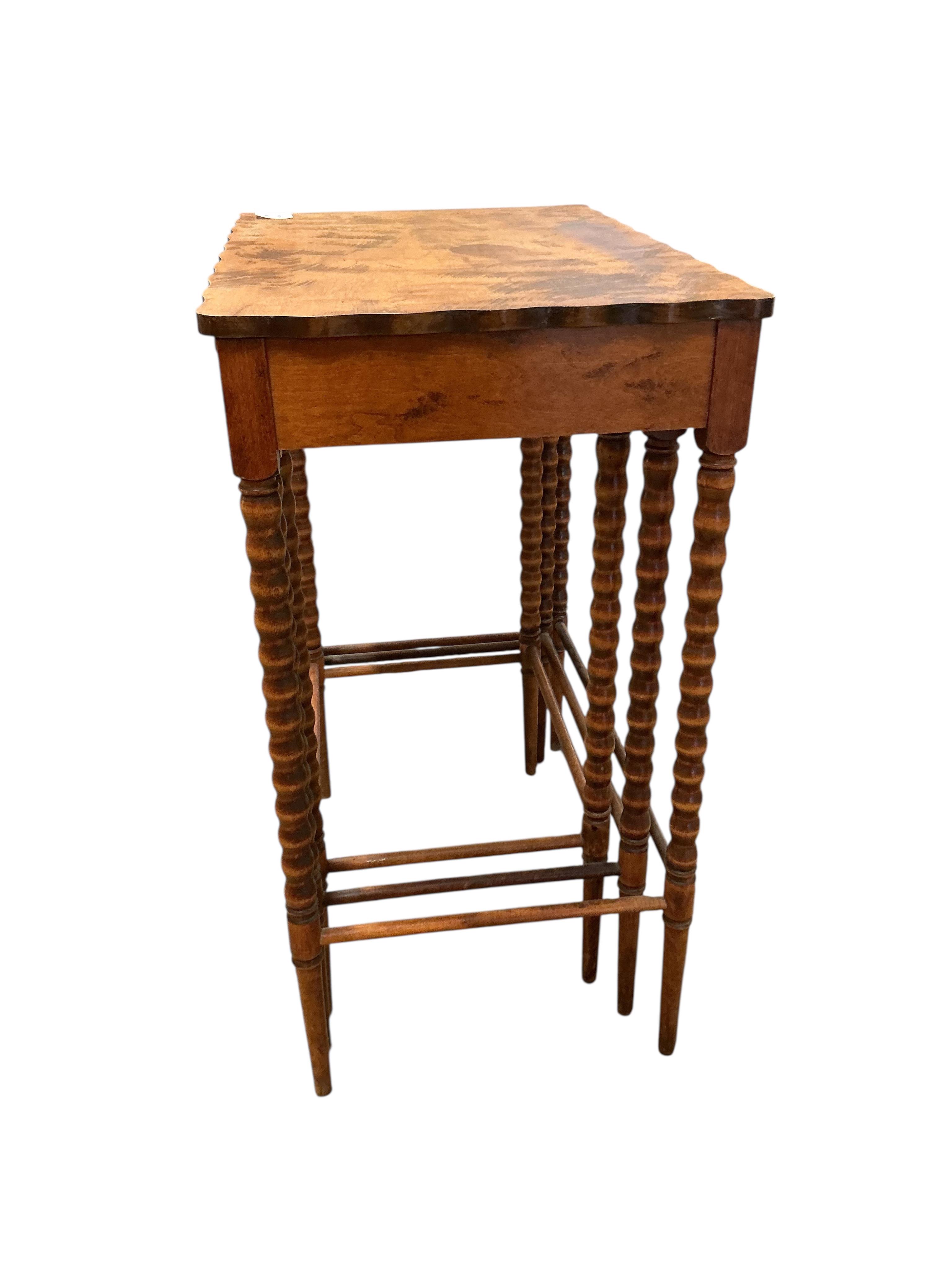 A nest of three rectangular beech tea tables, width 47cm, depth 32cm, height 59cm